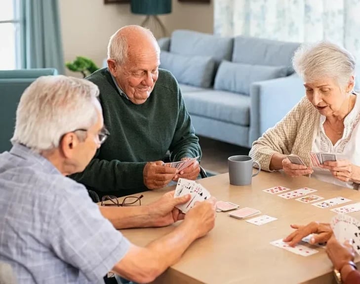 senior-friends-playing-cards-together-at-nursing-h-2021-09-02-08-35-18-utc-copy-e167769233365